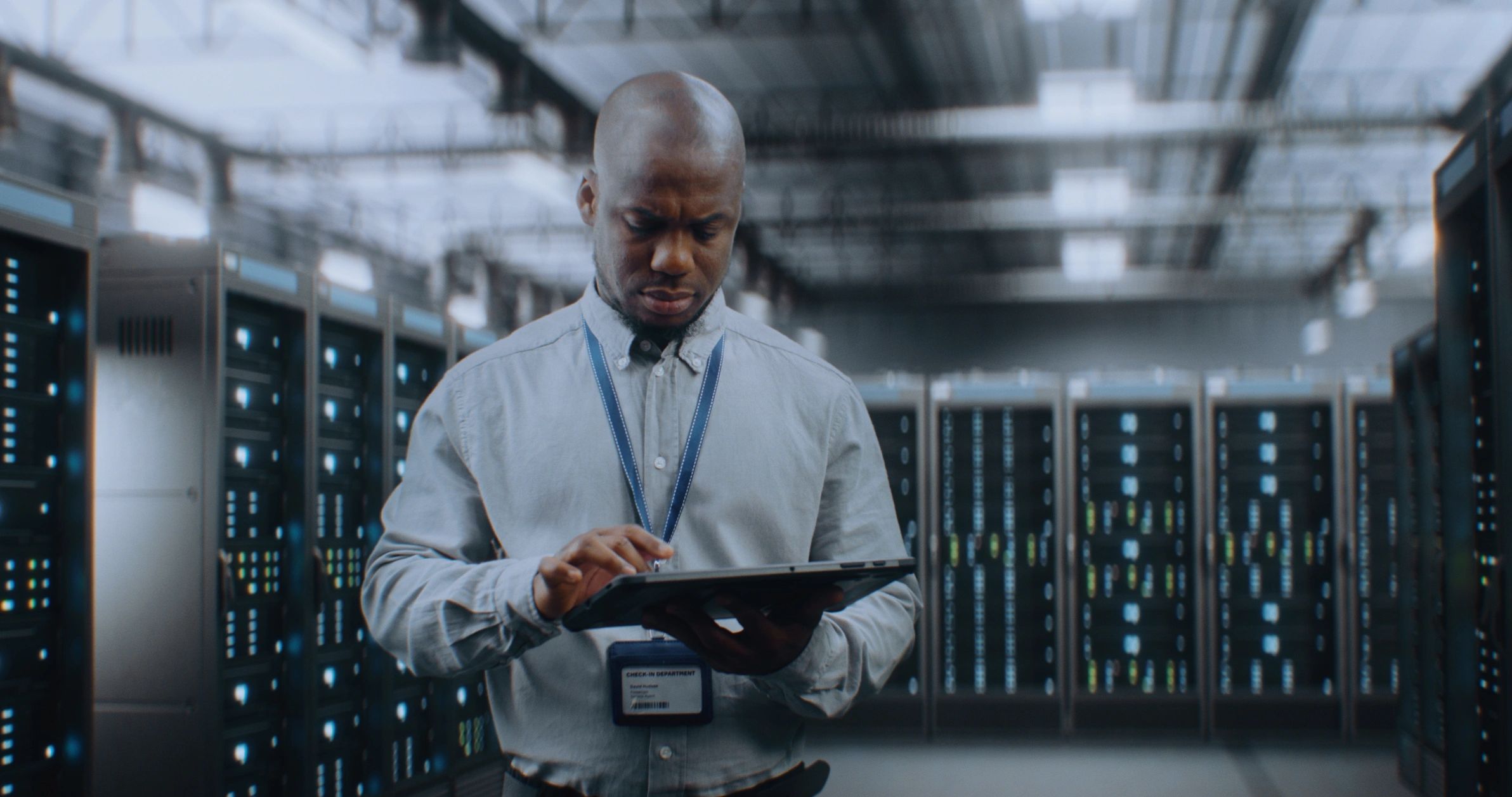 Technician using a tablet in a server room